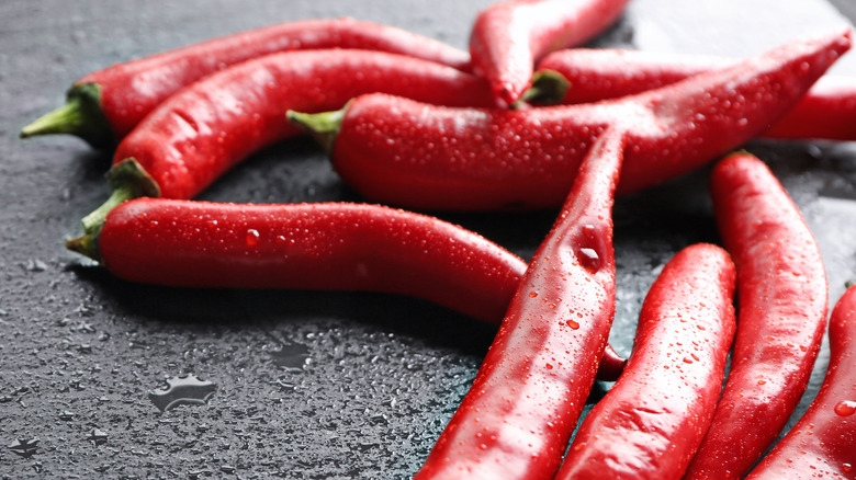 cayenne peppers spread out over a table