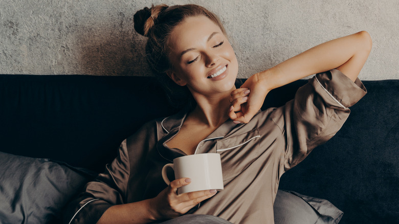 Woman drinking coffee in bed