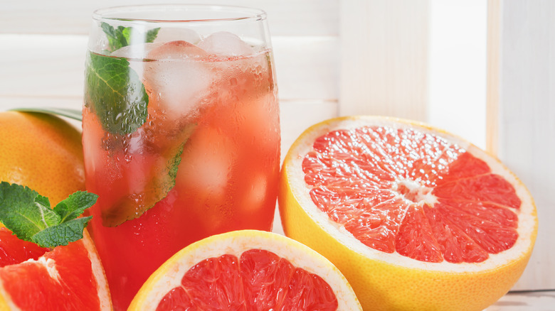 Grapefruit halves and juice with leaves