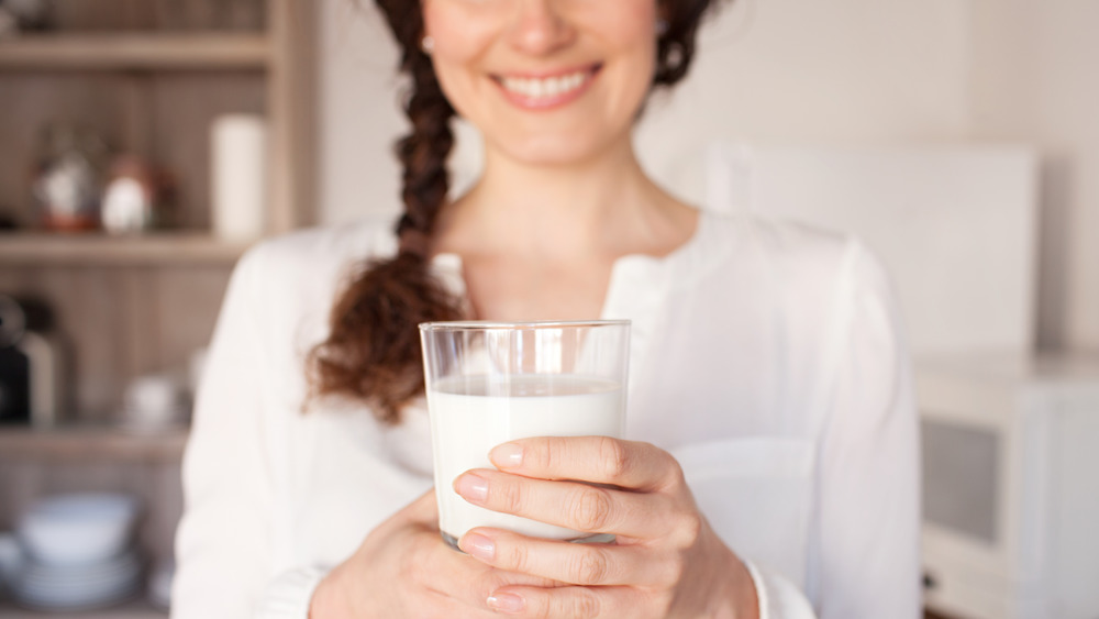 woman holding glass of milk
