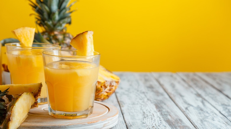 Two glasses of pineapple juice on a table