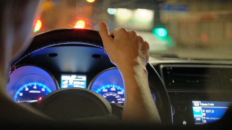 person driving car at night