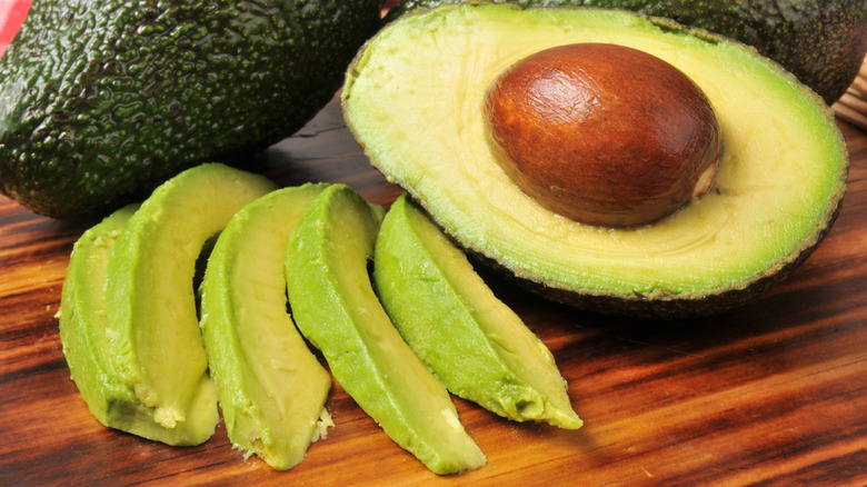 Avocado cut up on a cutting board
