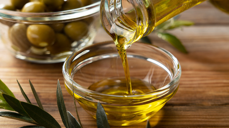 Olive oil poured into glass bowl