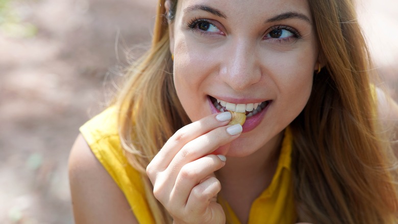 woman eating a cashew