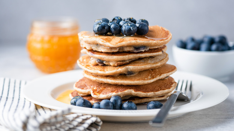 A stack of pancakes with blueberries on top