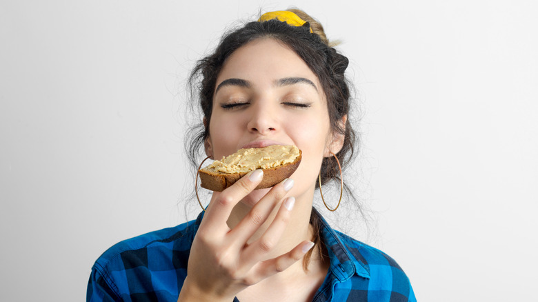 Woman eating peanut butter