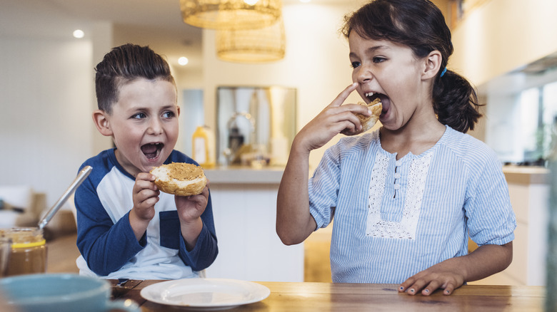 kids eating peanut butter on bread