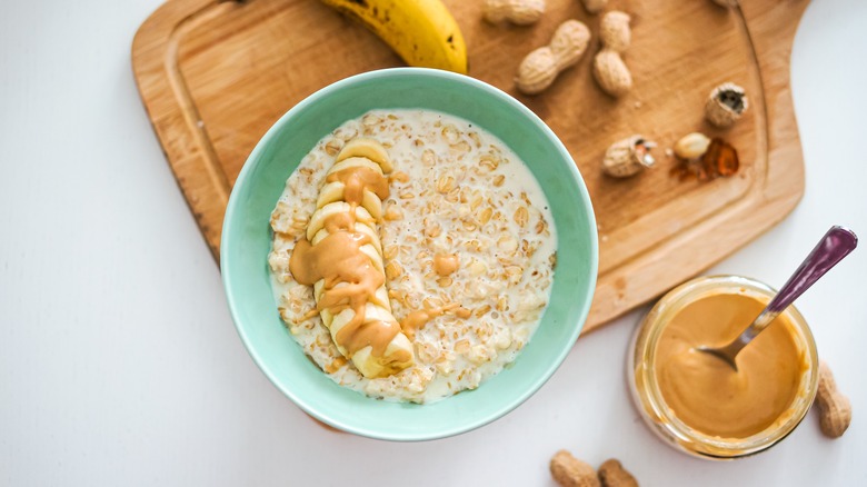 bowl of oatmeal topped with banana and peanut butter