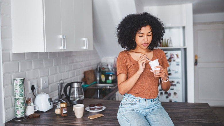 Woman eating yogurt