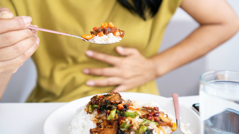 A woman eats spicy food