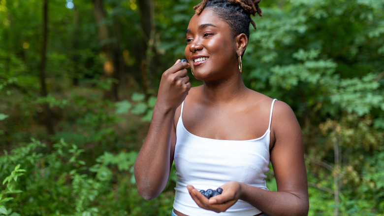 woman eating blueberries