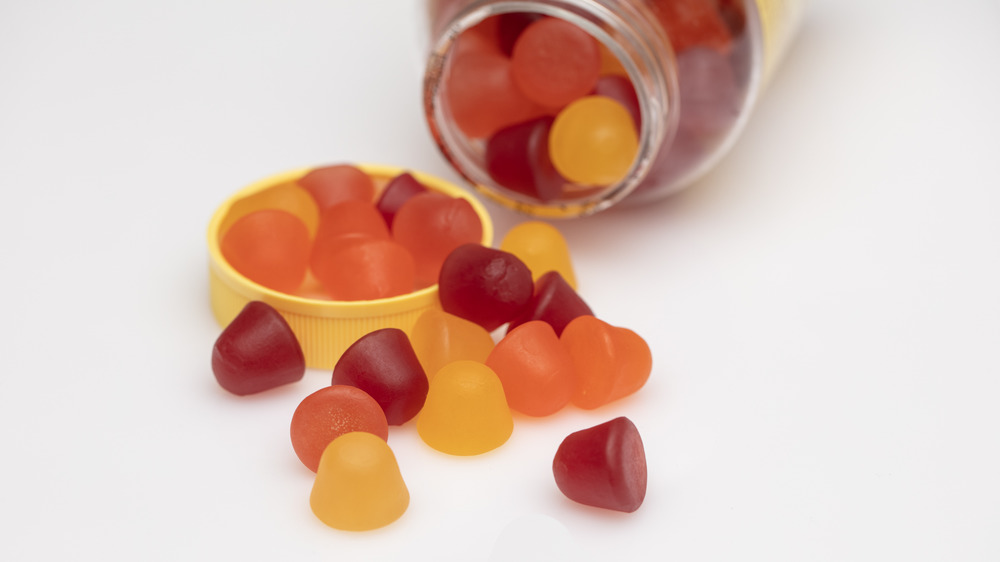 Vitamin gummies spilling out of jar