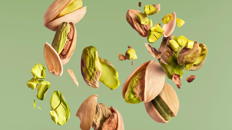 Pistachios on a green background