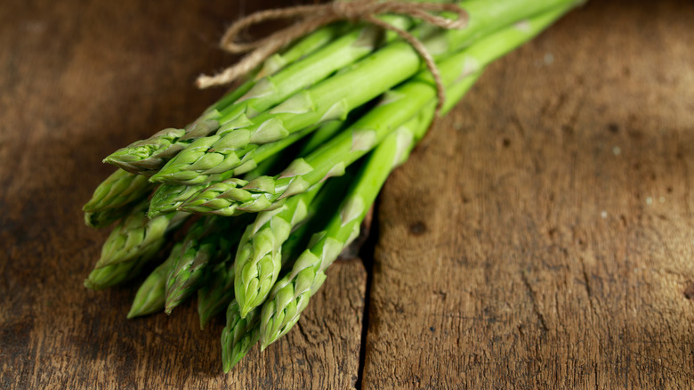 Fresh asparagus on a wooden cutting board