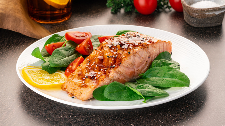 A plate of salmon and vegetables