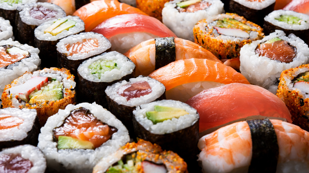 Many types of sushi displayed together in rows