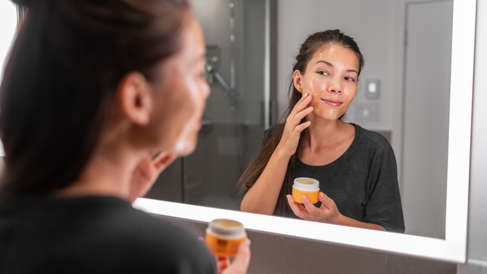 Woman applying face product