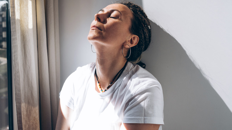 Woman leaning back against the wall