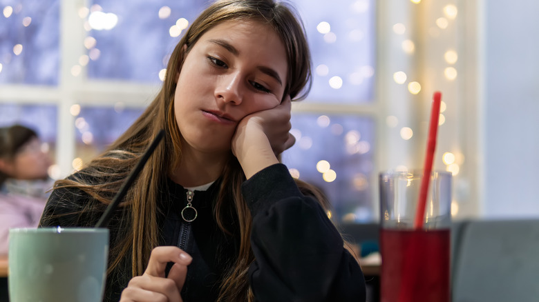 Girl with no appetite in a restaurant