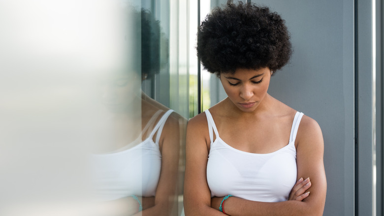 Woman with low self-esteem looking down