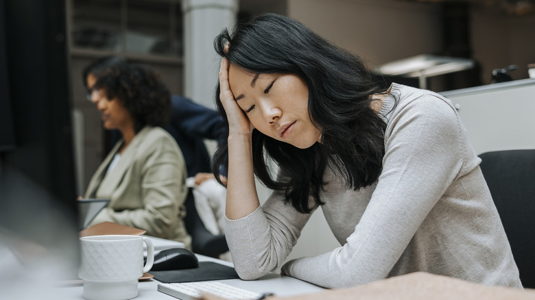 Woman looking tired while working