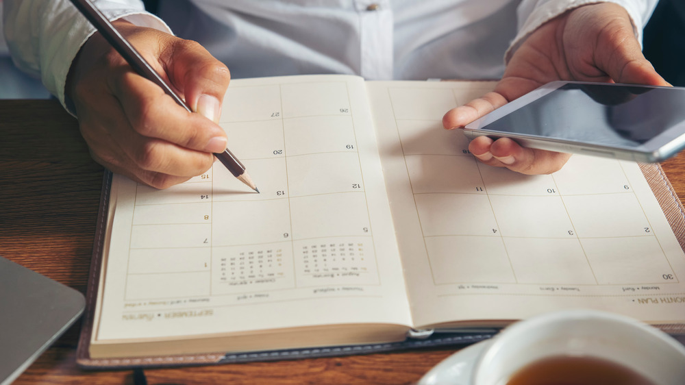 Someone scheduling in a calendar