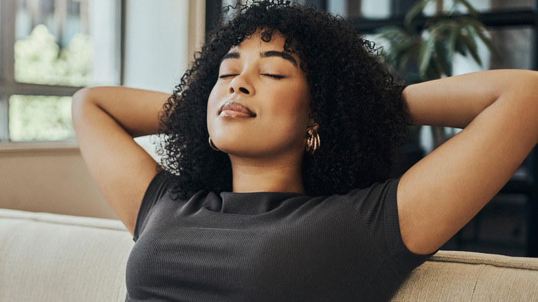 Woman leaning back on couch