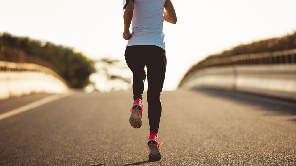 woman running down road