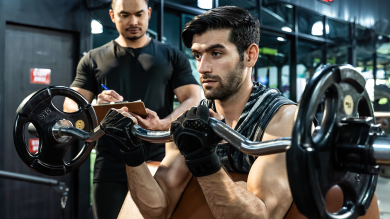 Man with trainer working out