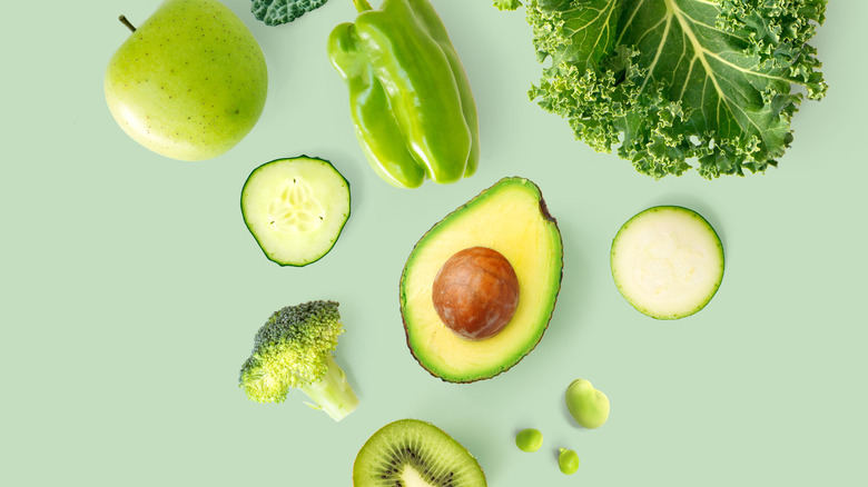 Basket of vegetables on green background
