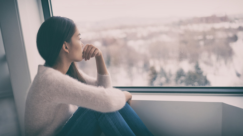 woman looking out of window