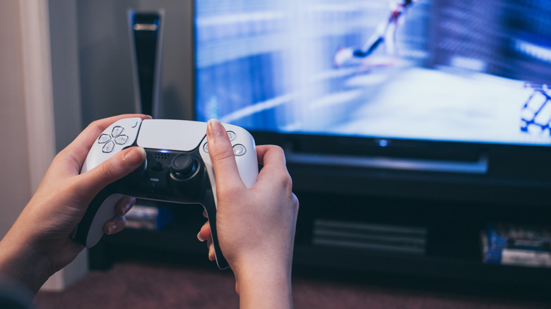 person holding games console