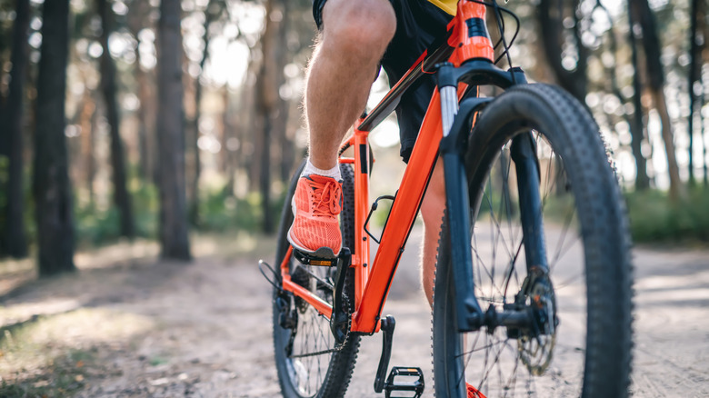 Man's legs riding bike