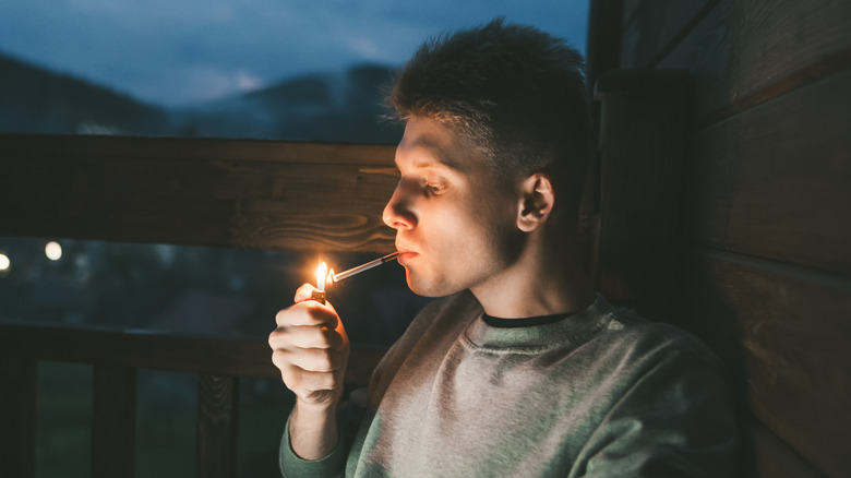 man smoking outside at night