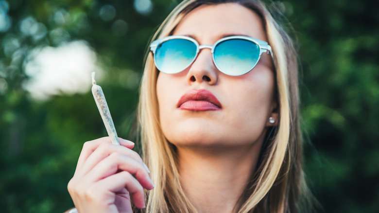 Woman in shades smoking marijuana