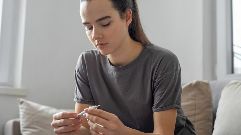 Woman holding marijuana joint