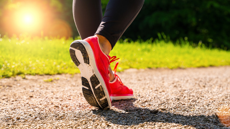 walking shoes on a dirt-paved road