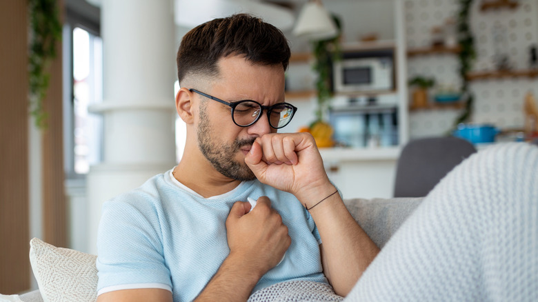 man coughing