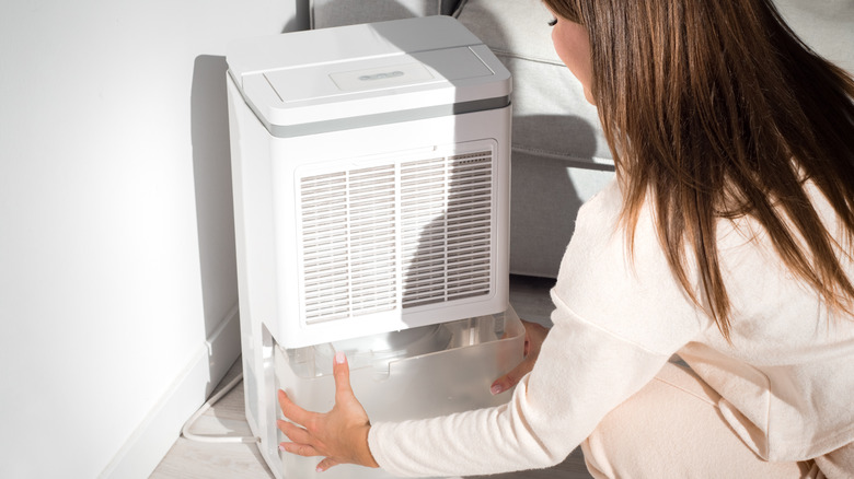 woman disassembling humidifier to clean