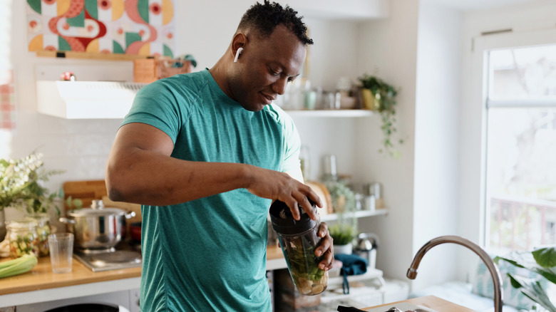 man making a protein shake