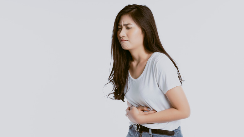 woman holding stomach