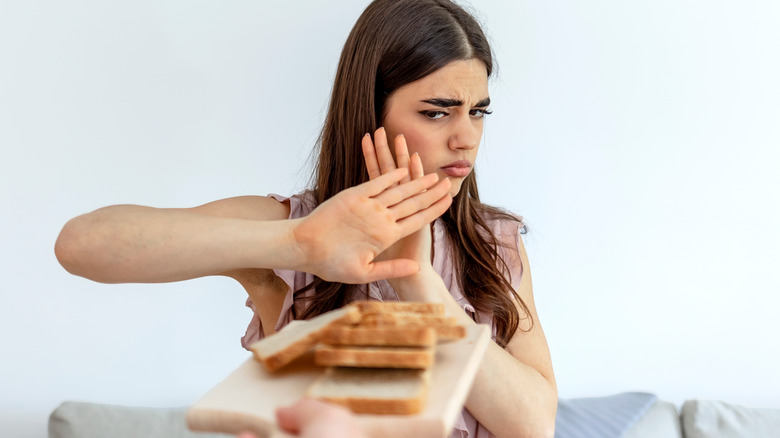 woman refusing bread 