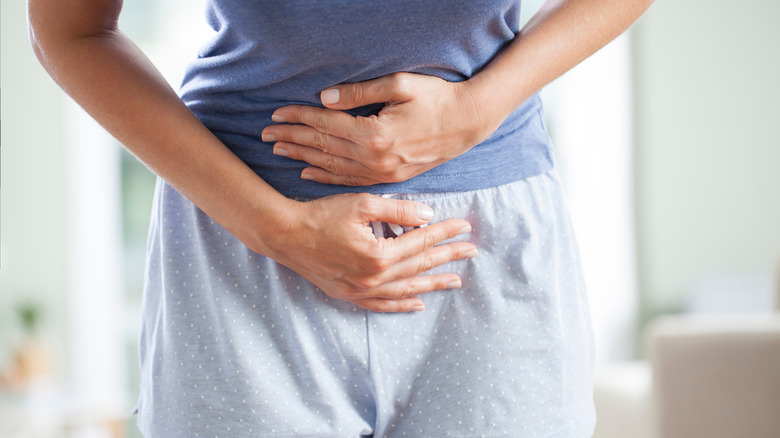 woman holding stomach