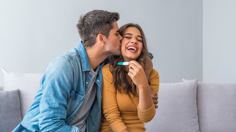 happy couple celebrate positive pregnancy test