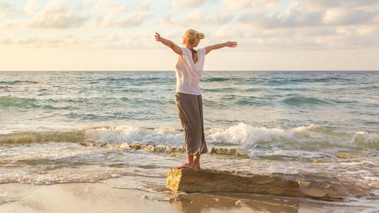 happy woman on the beach at sunset