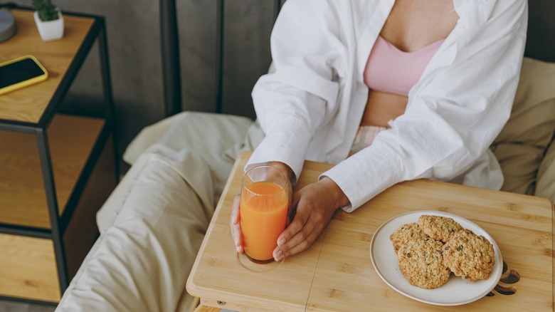 Woman eating in bed