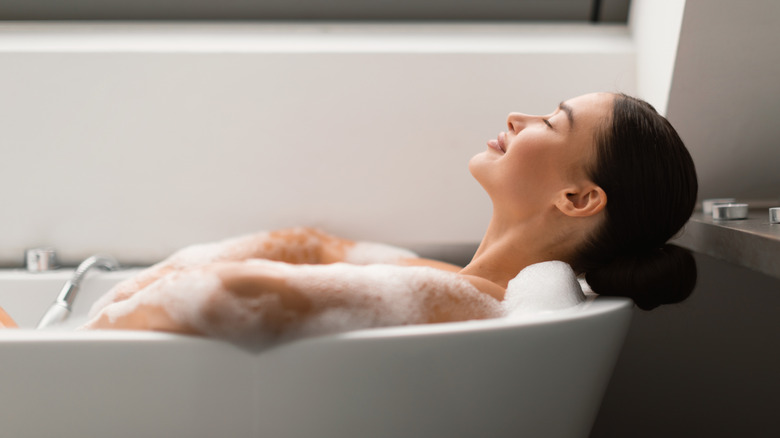 A woman relaxing in a bathtub