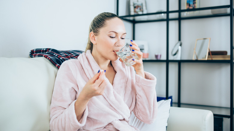 Woman taking a ibuprofen