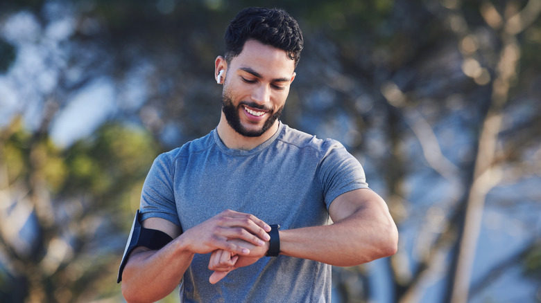 Man checking his fitness tracker while working out